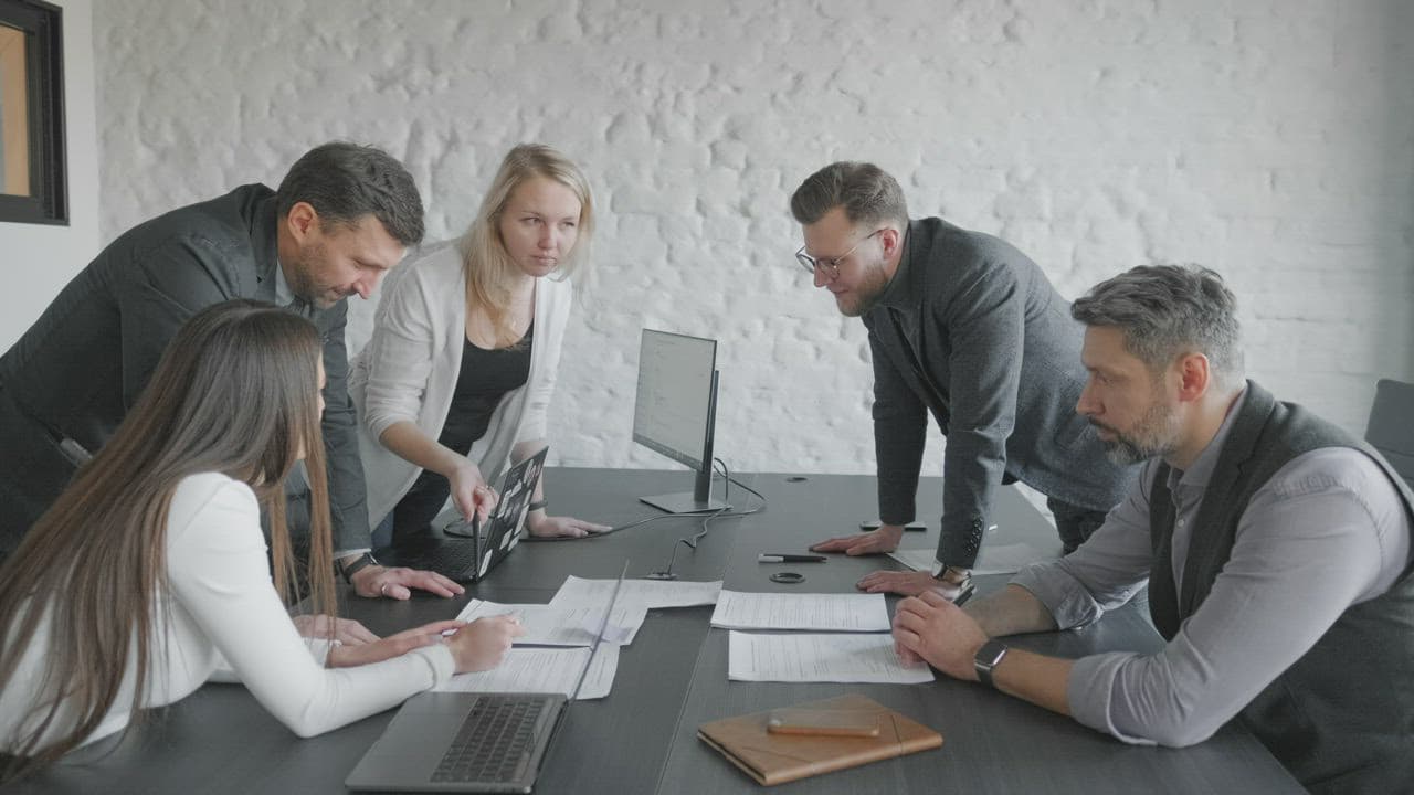 A team reviewing software delivery evidence across a shared workspace